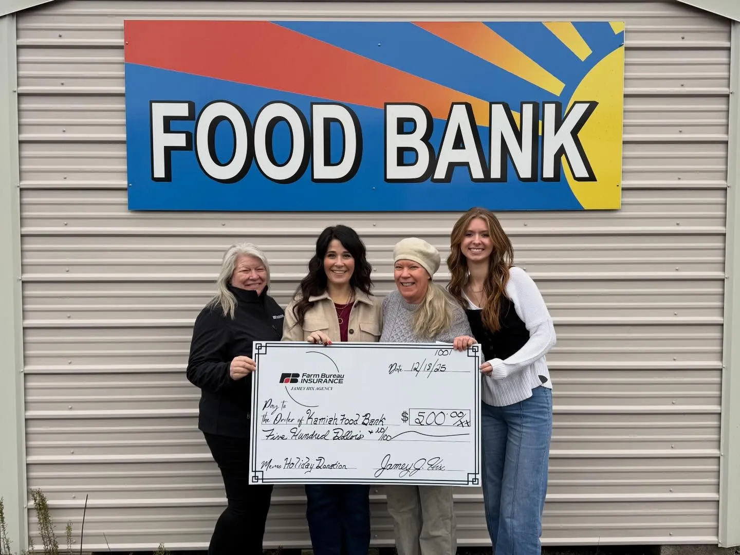 The Jamey Hix Agency team presenting a holiday donation check to the Kamiah Food Bank